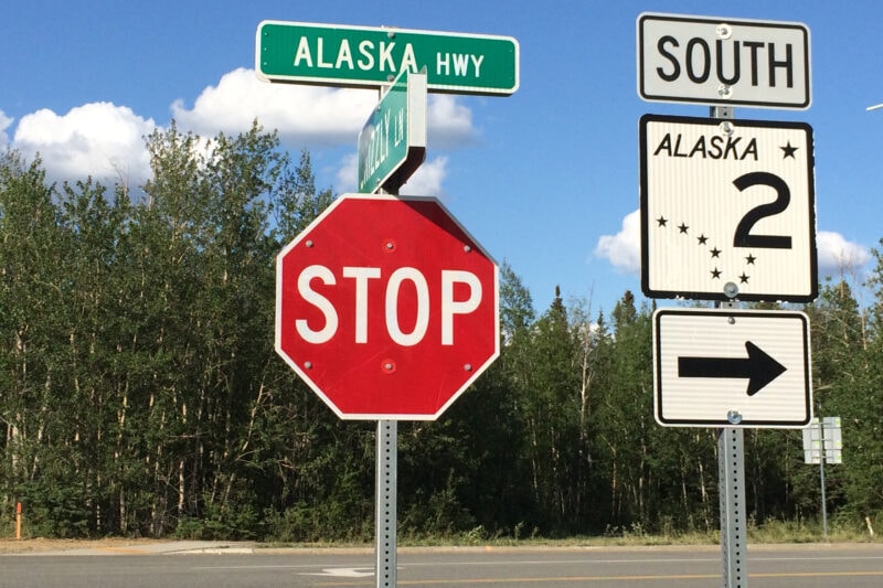 A roadsign for the Alaska Highway marks the route.
